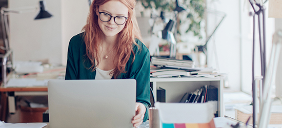 Woman using goldrushdispatch online customs forms tool on her laptop